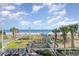 Community playground and easy beach access with palms, boardwalk, and sunny skies at 5300 N Ocean Blvd. # 217, Myrtle Beach, SC 29577