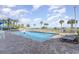 Outdoor swimming pool with lounge chairs and palm trees overlooking the beach on a sunny day at 5300 N Ocean Blvd. # 217, Myrtle Beach, SC 29577