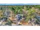 Aerial view of a brick home on a wooded lot with a long driveway at 100 Deloach Trail, Pawleys Island, SC 29585