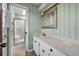 Bathroom featuring striped wallpaper, vanity, mirror, and a shower stall with gold trim at 100 Deloach Trail, Pawleys Island, SC 29585