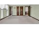 Bedroom with three interior doors and carpeted floors. Two windows are adorned with white curtains at 100 Deloach Trail, Pawleys Island, SC 29585