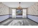 Traditional dining room featuring a chandelier, wallpaper, and large window with sheer white curtains at 100 Deloach Trail, Pawleys Island, SC 29585