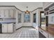 Kitchen nook with black and white tile, pastel cabinets, a colorful hanging light and three windows at 100 Deloach Trail, Pawleys Island, SC 29585
