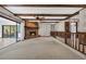 Warm living room with a brick fireplace and large sliding glass doors, offering a cozy retreat at 100 Deloach Trail, Pawleys Island, SC 29585