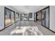 Sun-drenched sunroom with tile flooring, ceiling fan and glass doors leading to the backyard at 100 Deloach Trail, Pawleys Island, SC 29585