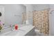 Well-lit bathroom featuring a modern vanity, stylish mirror, and a shower with a charming floral curtain at 107 Ben Horry Trail, Pawleys Island, SC 29585