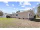 Tan single story home with a brick foundation and a well manicured lawn at 107 Ben Horry Trail, Pawleys Island, SC 29585