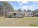 Charming single-story home with a welcoming front porch and well-maintained lawn at 107 Ben Horry Trail, Pawleys Island, SC 29585