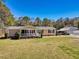 Charming single story home with a welcoming front porch, mature landscaping, and detached garage at 107 Ben Horry Trail, Pawleys Island, SC 29585