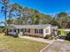 Well-maintained single story home with manicured lawn, inviting front porch, and mature trees at 107 Ben Horry Trail, Pawleys Island, SC 29585