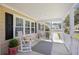 Cozy front porch with rocking chairs, offering a relaxing view of the neighborhood at 107 Ben Horry Trail, Pawleys Island, SC 29585