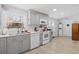 A view of the kitchen featuring gray cabinets and modern white appliances at 107 Ben Horry Trail, Pawleys Island, SC 29585