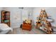 Comfortable sitting area with a patterned throw blanket, wooden display shelves, and sunlit windows at 107 Ben Horry Trail, Pawleys Island, SC 29585