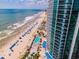 Aerial view of the beautiful beach, pools, and resort building with balconies with ocean views at 107 S Ocean Blvd. # 704, Myrtle Beach, SC 29577
