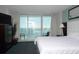Bright bedroom with a plush bed, ocean view balcony, and modern decor at 107 S Ocean Blvd. # 704, Myrtle Beach, SC 29577