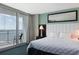 Bedroom featuring a balcony with ocean views and a comfortable bed at 107 S Ocean Blvd. # 704, Myrtle Beach, SC 29577
