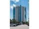 Modern resort exterior featuring stylish architecture, palm trees, and convenient parking at 107 S Ocean Blvd. # 704, Myrtle Beach, SC 29577