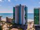 Modern building with ocean view with lush landscaping and parking at 107 S Ocean Blvd. # 704, Myrtle Beach, SC 29577