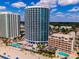 Aerial view of multiple resort buildings and beach with clear blue sky with clouds at 107 S Ocean Blvd. # 704, Myrtle Beach, SC 29577