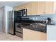 Kitchen area features stainless steel appliances, light wood cabinets, and dark countertops at 107 S Ocean Blvd. # 704, Myrtle Beach, SC 29577
