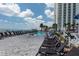 Outdoor pool with lounge chairs overlooking the beach and ocean, adjacent to a high-rise condominium at 107 S Ocean Blvd. # 704, Myrtle Beach, SC 29577