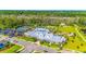 Beautiful aerial view of the community pool, clubhouse, tennis courts, and surrounding green spaces at 1309 Suncrest Dr., Myrtle Beach, SC 29577