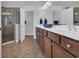 Bathroom featuring a double sink vanity and glass shower with tile surround at 1309 Suncrest Dr., Myrtle Beach, SC 29577