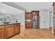 An open kitchen features wooden floors, stainless steel appliances, and granite countertops for a modern aesthetic at 1309 Suncrest Dr., Myrtle Beach, SC 29577