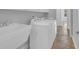 Well-lit laundry room with a white utility sink and a white washer and dryer set at 1309 Suncrest Dr., Myrtle Beach, SC 29577