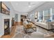 Bright living room with fireplace, hardwood floors, large windows, and a neutral color palette at 1309 Suncrest Dr., Myrtle Beach, SC 29577