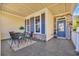 Relaxing outdoor covered porch with table, chairs, welcome sign, and stone accents at 1309 Suncrest Dr., Myrtle Beach, SC 29577