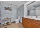 Well-lit bathroom with tile floors, wooden vanity, neutral color walls, and decorative seashell accent at 1321 S Ocean Blvd. # 510, North Myrtle Beach, SC 29582
