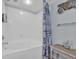 Updated bathroom shower with decorative shower curtain and seashell decoration on the wall at 1321 S Ocean Blvd. # 510, North Myrtle Beach, SC 29582