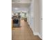 Comfortable condo hallway leading to a living room with a ceiling fan and bright windows at 1321 S Ocean Blvd. # 510, North Myrtle Beach, SC 29582