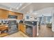 Clean kitchen with stainless steel appliances and wood cabinets connects to the living room at 1321 S Ocean Blvd. # 510, North Myrtle Beach, SC 29582
