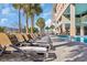 Array of poolside loungers with palm trees set alongside a shared community swimming pool at 1321 S Ocean Blvd. # 510, North Myrtle Beach, SC 29582