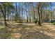 Secluded backyard with stone-paved bench, lush landscaping, tall trees and tranquil setting at 138 Wofford Rd., Conway, SC 29526
