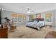 Cozy bedroom featuring a ceiling fan, rocking chair, and natural light from multiple windows at 138 Wofford Rd., Conway, SC 29526