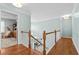 Bright and airy upstairs hallway with wood floors, white trim, leading to bedrooms and living spaces at 138 Wofford Rd., Conway, SC 29526