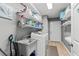 Laundry room featuring a utility sink, washing machine, shelving, and tile flooring at 138 Wofford Rd., Conway, SC 29526