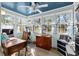 Bright sun room with a beadboard ceiling, many windows, and wood flooring at 138 Wofford Rd., Conway, SC 29526
