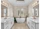 Bright bathroom featuring a soaking tub, dual vanities, white cabinetry, and neutral walls at 1549 Casita Ln., Myrtle Beach, SC 29579