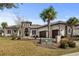 Elegant stucco home with a tile roof, stone accents, and a well-manicured front yard at 1549 Casita Ln., Myrtle Beach, SC 29579