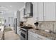 Modern kitchen with stainless steel appliances, granite countertops, and stylish tile backsplash at 1549 Casita Ln., Myrtle Beach, SC 29579
