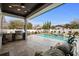 Outdoor living area features a sparkling pool, spa, outdoor grill, and covered dining at 1549 Casita Ln., Myrtle Beach, SC 29579