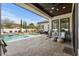 Beautiful backyard features a swimming pool, spa, and outdoor seating area with a covered patio at 1549 Casita Ln., Myrtle Beach, SC 29579