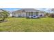 Lush backyard featuring a well-manicured lawn, a screened porch, and an outdoor grill area, perfect for outdoor living at 171 Talon Dr., Conway, SC 29527
