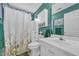 Bathroom featuring a shower with a patterned curtain, a white vanity, and green accent towels for a fresh, clean aesthetic at 171 Talon Dr., Conway, SC 29527