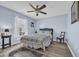 Cozy bedroom with light blue walls, wood-look flooring, a ceiling fan, and a window with white blinds for natural light at 171 Talon Dr., Conway, SC 29527