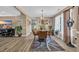 Dining room featuring hardwood floors, a stylish chandelier, and large windows that provide natural light at 171 Talon Dr., Conway, SC 29527